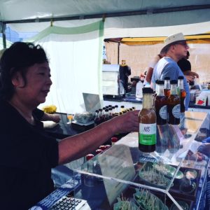 Kei flogs the dressings, at our last market stall